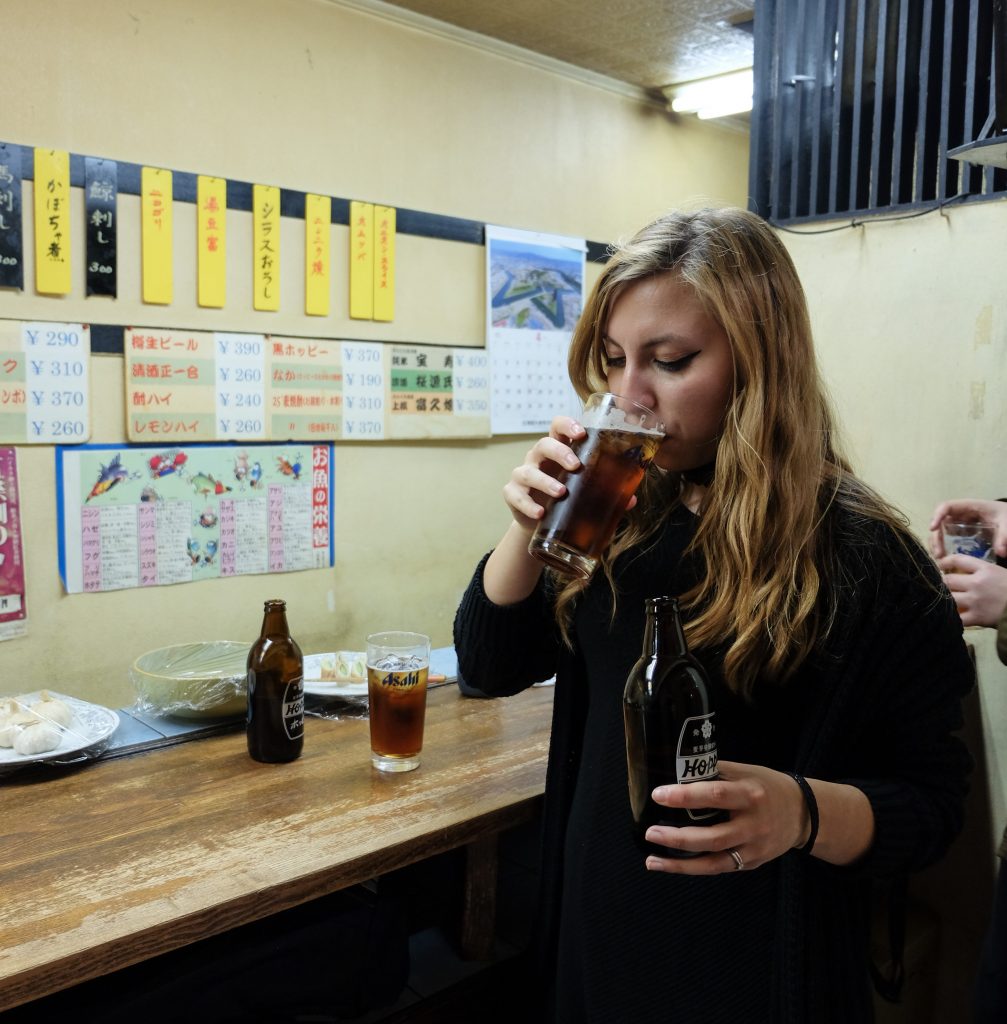 Cory from You Could Travel drinking in a pub in Tokyo