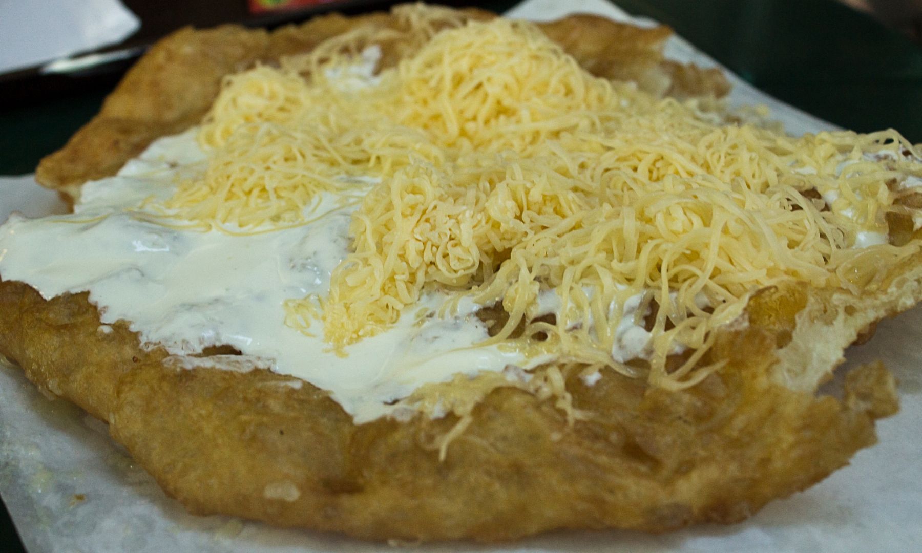 Traditional Langos Topped with Sourcream and Cheese