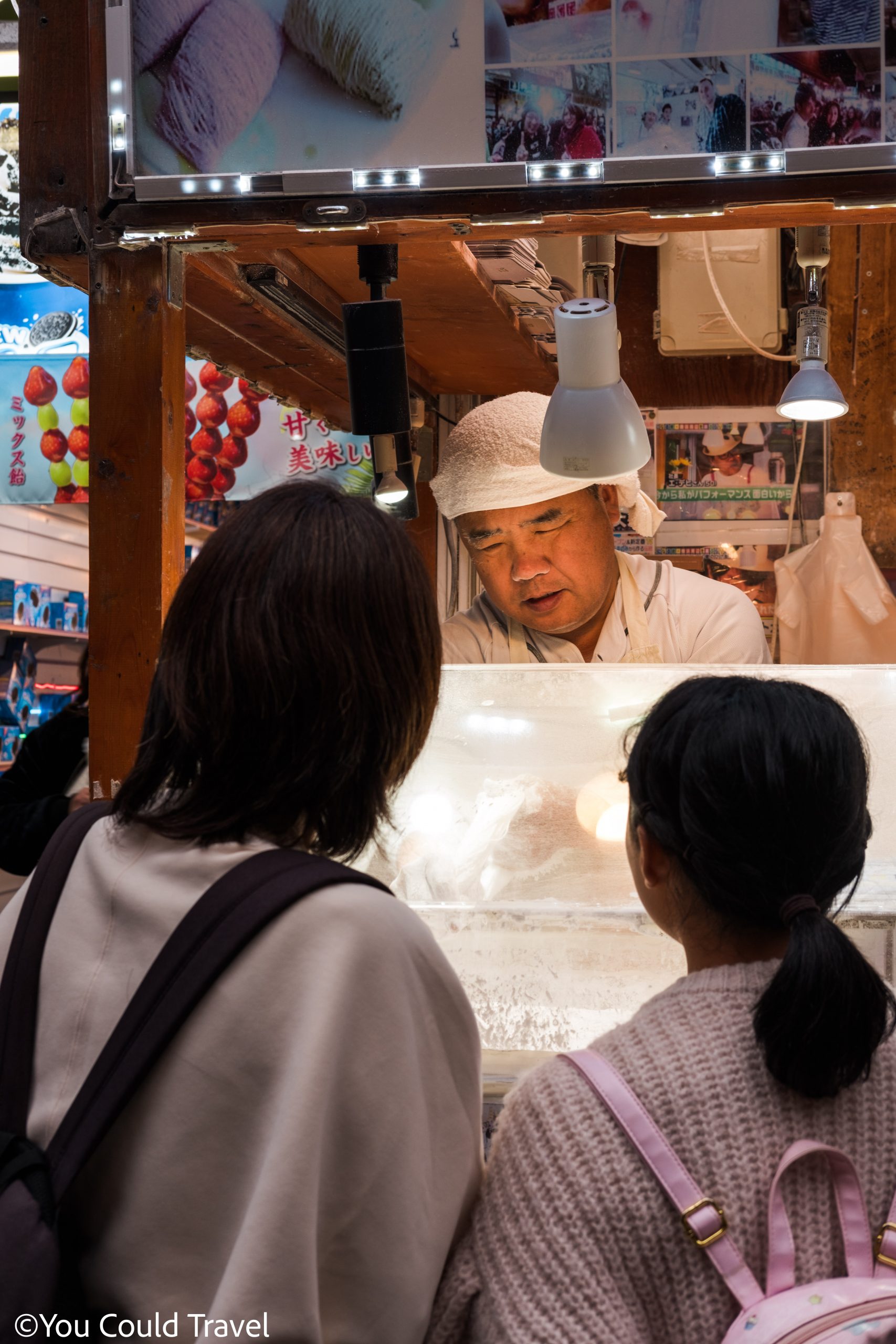 Two locals ordering sweets from a stall in Yokohama Chinatown