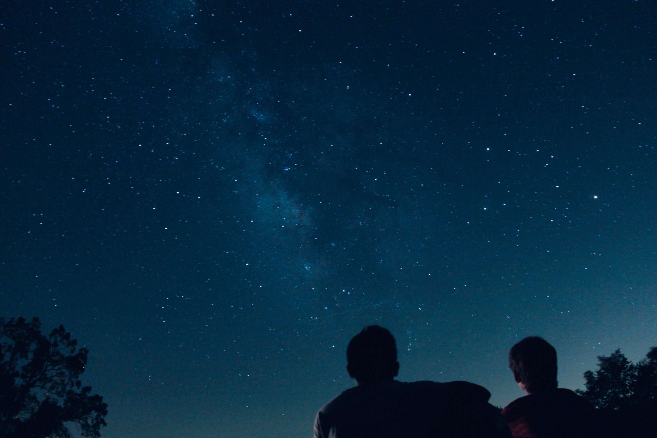 Two people stargazing - dark sky reserve England 