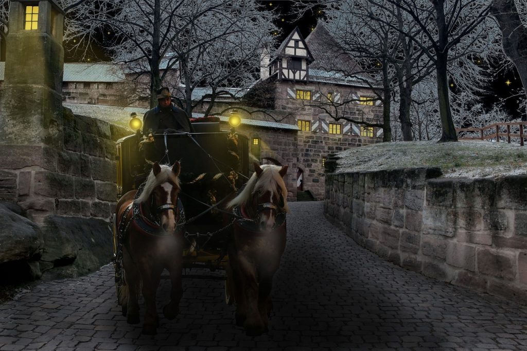 A carriage pulled by two beautiful horses on a small cobbled alley in Transylvania