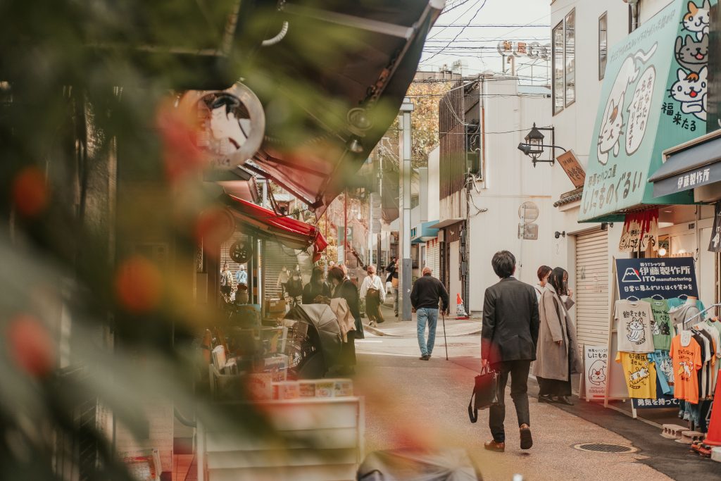 Salary man dressed in a suit walking in Yanaka Ginza