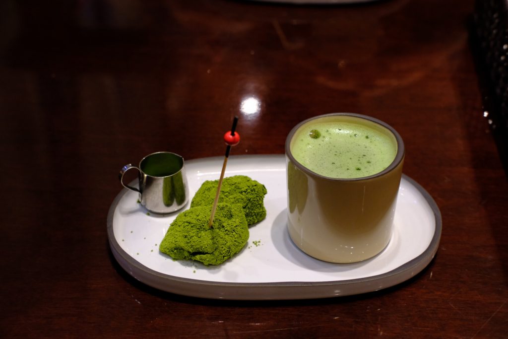 Warabimochi covered in matcha and served with a side of matcha tea
