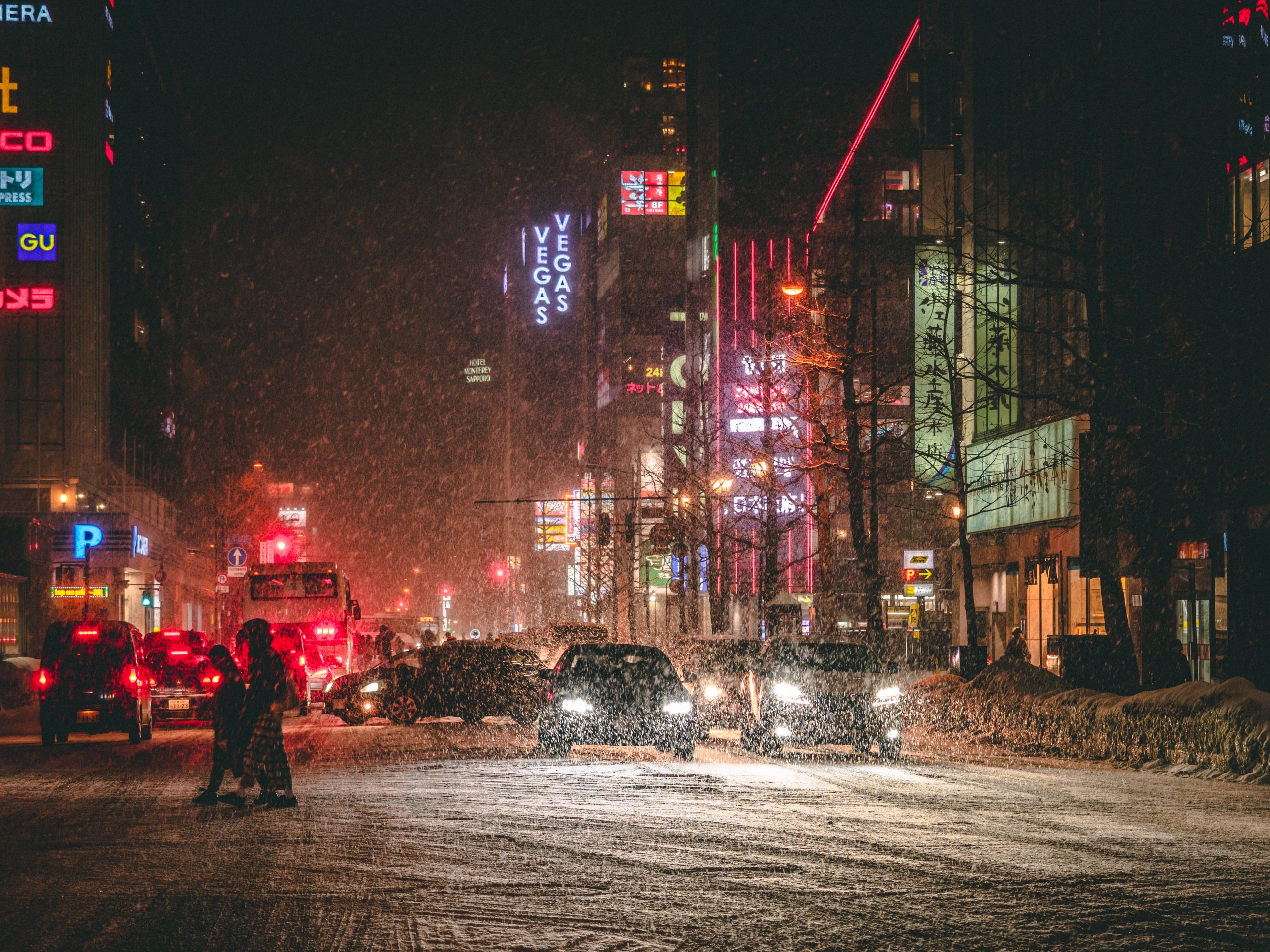 Where to stay in Sapporo - city snow at night with neon lights