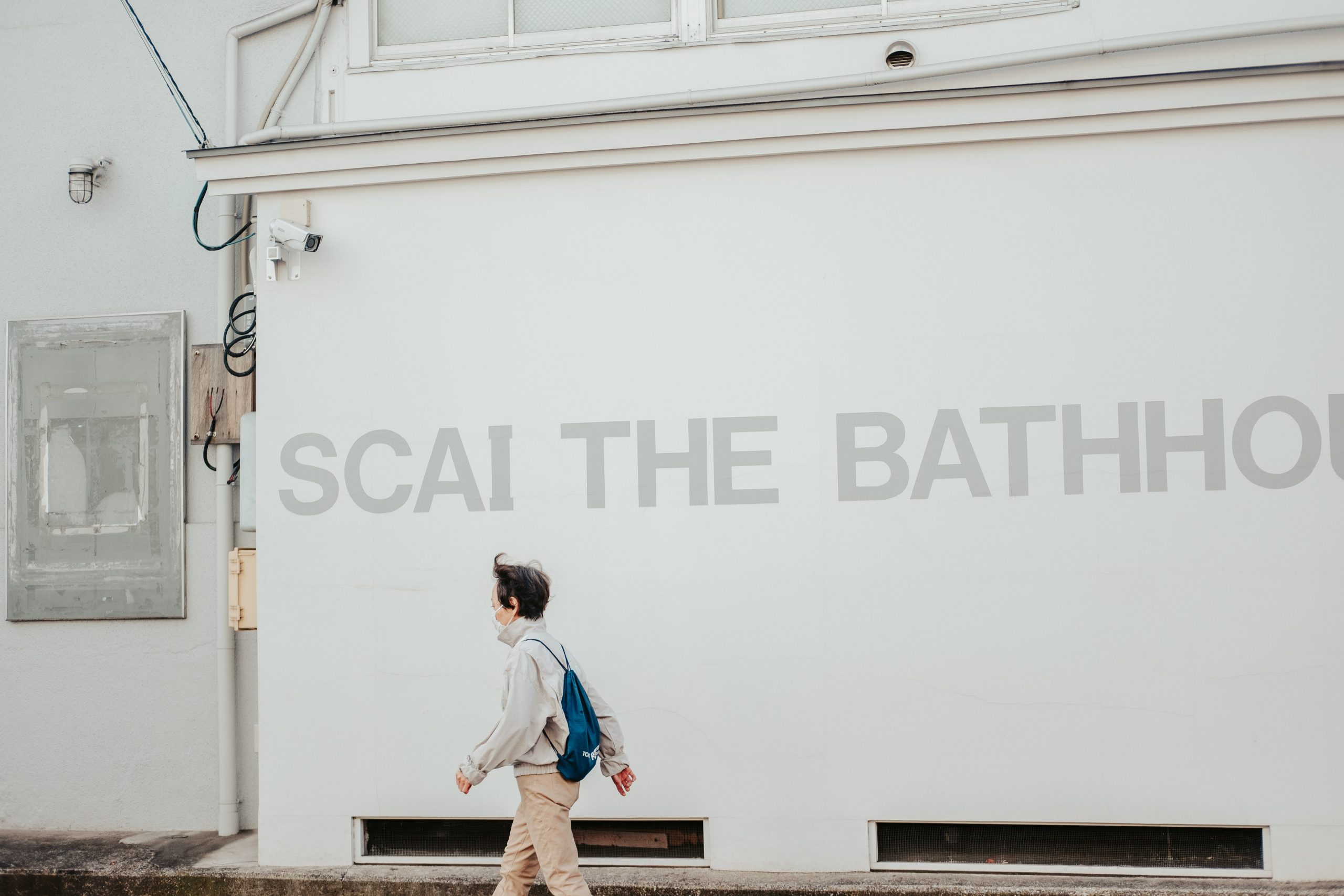 Woman walking in front of Scai the Bathhouse